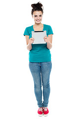 Image showing Full length portrait of pretty girl holding tablet pc