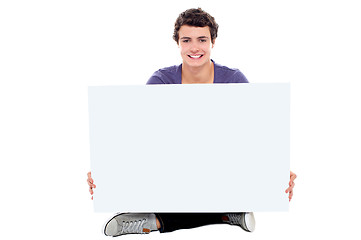 Image showing Teenager showing blank white billboard to camera