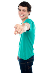 Image showing Casual teen guy pointing at you