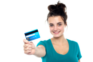 Image showing Girl showing her cash card, arm stretched out