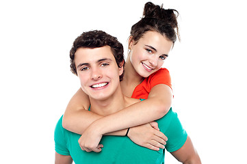 Image showing Young boy giving his girlfriend piggyback ride