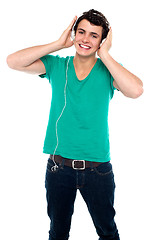 Image showing Cheerful guy enjoying loud music