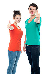 Image showing Teen love couple showing thumbs up to camera