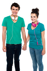 Image showing Young couple with headphones around their necks