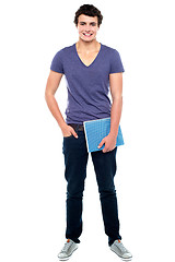 Image showing Stylish college student posing with notebook in hand
