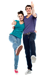 Image showing Teen love couple enjoying themselves, gesturing thumbs up