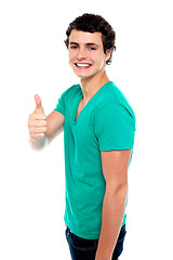 Image showing Cheerful teenager showing thumbs up to camera