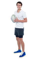 Image showing Full length portrait of a rugby player holding ball