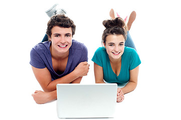 Image showing Teen friends enjoying video on laptop together