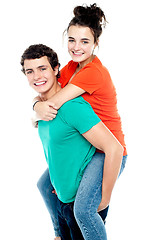 Image showing Happy young girl enjoying piggyback ride on her boyfriend back
