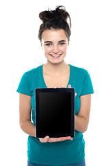 Image showing Casual teenager showing newly launched tablet device