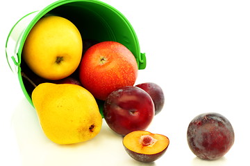 Image showing Summer fruits spilling from green bucket.