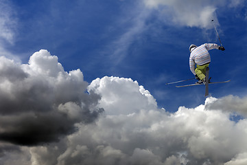 Image showing Freestyle ski jumper with crossed skis