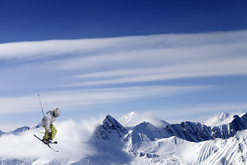 Image showing Freestyle ski jumper with crossed skis