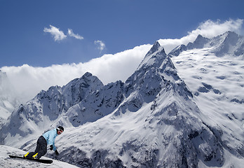 Image showing Snowboarder descends a slope