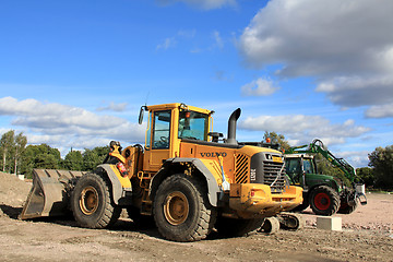Image showing One loader and grapple tractor at construction site