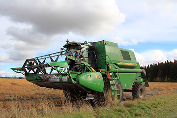 Image showing Modern combine harvester by wet field