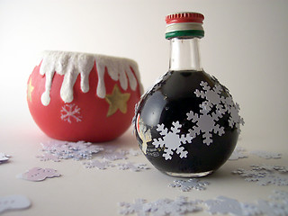 Image showing xmas candle and liquor bottle