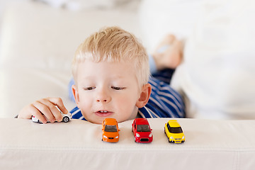 Image showing toddler plays toy cars