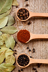 Image showing three kinds of pepper and bay leaves