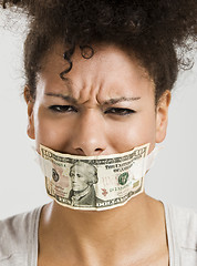 Image showing Covering mouth with a dollar banknote