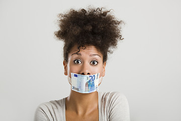 Image showing Covering mouth with a euro banknote