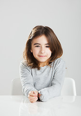 Image showing Little girl in a desk
