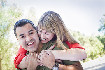 Image showing Attractive Mixed Race Couple Piggyback at the Park