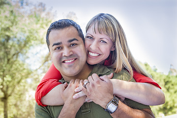 Image showing Attractive Mixed Race Couple Piggyback at the Park