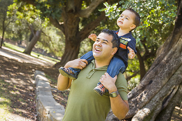 Image showing Mixed Race Son Enjoy a Piggy Back in the Park with Dad