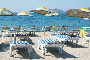 Image showing Loungers and umbrellas on beach