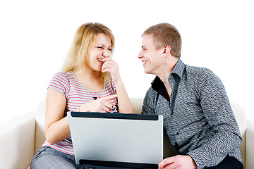 Image showing young couple with a laptop on the background of isolation