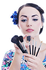 Image showing beautiful young woman applying makeup