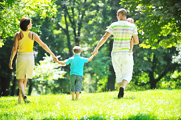 Image showing happy young couple with their children have fun at park