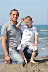 Image showing happy father and son have fun and enjoy time on beach