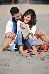 Image showing young couple enjoying  picnic on the beach