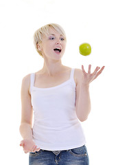 Image showing happy  young  woman eat green apple isolated  on white