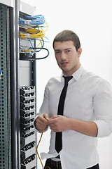 Image showing young it engeneer in datacenter server room