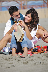 Image showing young couple enjoying  picnic on the beach