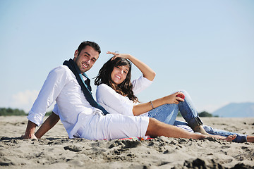 Image showing young couple enjoying  picnic on the beach