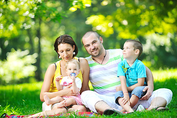 Image showing happy young couple with their children have fun at park