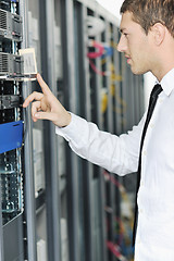 Image showing young it engeneer in datacenter server room