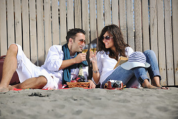 Image showing young couple enjoying  picnic on the beach