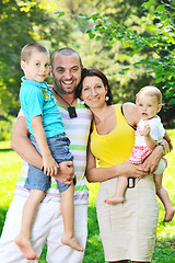 Image showing happy young couple with their children have fun at park