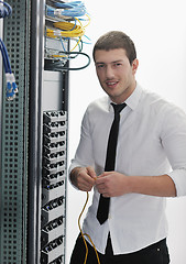 Image showing young it engeneer in datacenter server room