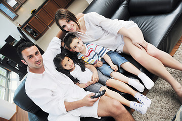 Image showing family wathching flat tv at modern home indoor