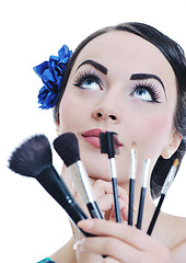 Image showing beautiful young woman applying makeup