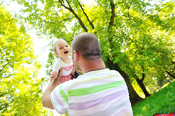 Image showing man and baby playing in park