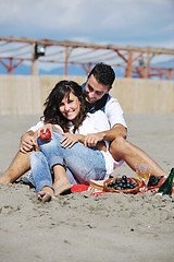 Image showing young couple enjoying  picnic on the beach
