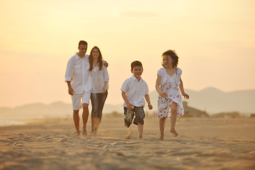 Image showing happy young family have fun on beach at sunset